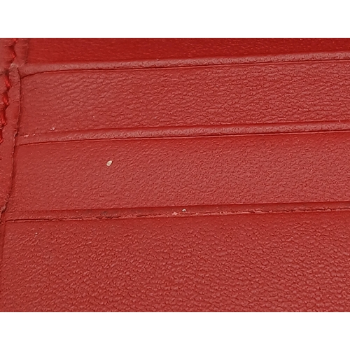 549 - A Gucci GG Supreme Cherry Card Holder Wallet. Ebony GG Supreme canvas exterior with gold-tone hardwa... 