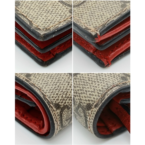 549 - A Gucci GG Supreme Cherry Card Holder Wallet. Ebony GG Supreme canvas exterior with gold-tone hardwa... 