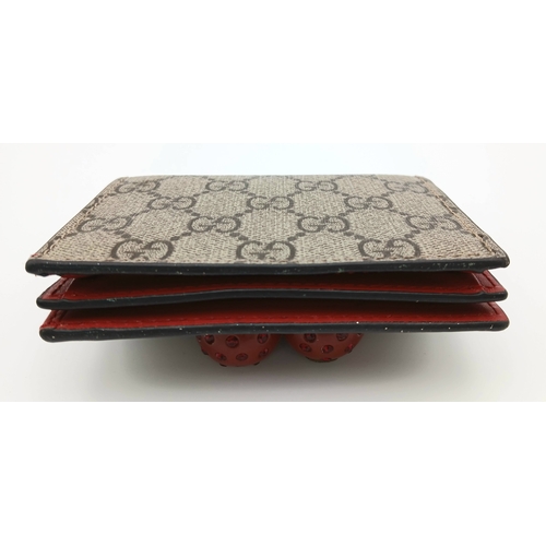549 - A Gucci GG Supreme Cherry Card Holder Wallet. Ebony GG Supreme canvas exterior with gold-tone hardwa... 