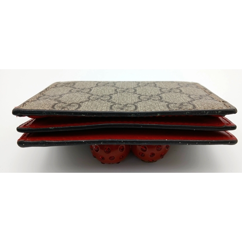 549 - A Gucci GG Supreme Cherry Card Holder Wallet. Ebony GG Supreme canvas exterior with gold-tone hardwa... 