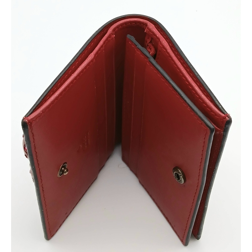 549 - A Gucci GG Supreme Cherry Card Holder Wallet. Ebony GG Supreme canvas exterior with gold-tone hardwa... 