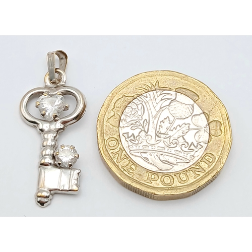 554 - 18K white gold cz key pendant, 0.8g total weight.  SH2461I