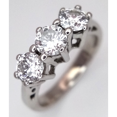 An 18K White Gold Three Stone Diamond Ring. c. 1.10ctw of round brilliant cut diamonds. SI1 clarity with F-H colour. Size I 1/2. 4.4g total weight. R0336/36503.