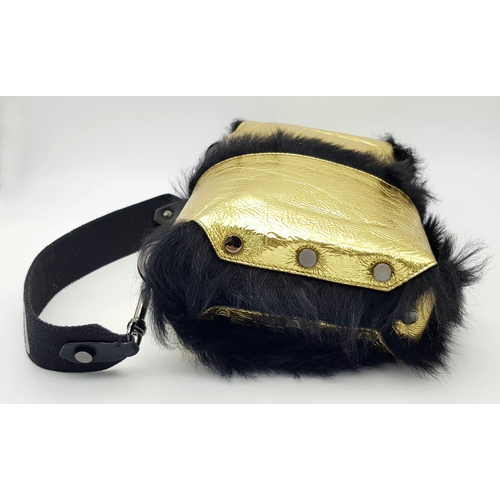 1006 - A Jimmy Choo Gold Metallic Textile and Black Fur Shoulder Bag. Gold metallic textile exterior with b... 