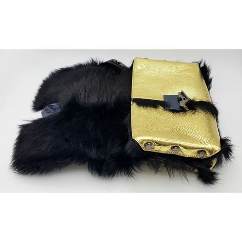 1006 - A Jimmy Choo Gold Metallic Textile and Black Fur Shoulder Bag. Gold metallic textile exterior with b... 