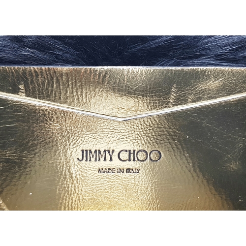 1006 - A Jimmy Choo Gold Metallic Textile and Black Fur Shoulder Bag. Gold metallic textile exterior with b... 