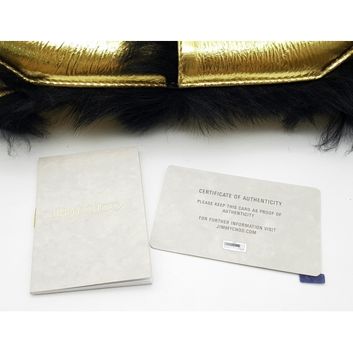 1006 - A Jimmy Choo Gold Metallic Textile and Black Fur Shoulder Bag. Gold metallic textile exterior with b... 