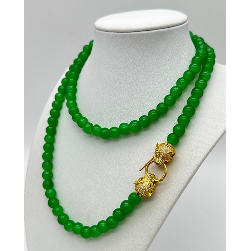 1039 - A Matinee Length Green Agate Bead Necklace with Gilded Twin Panther Clasp. 78cm. ML13.