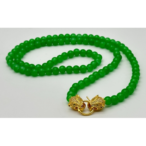 1039 - A Matinee Length Green Agate Bead Necklace with Gilded Twin Panther Clasp. 78cm. ML13.