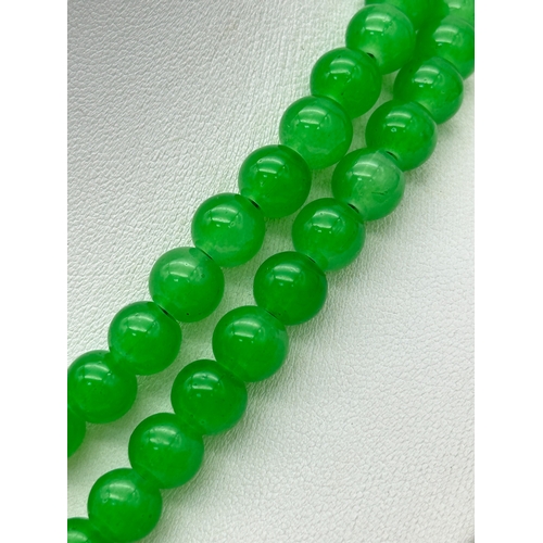 1039 - A Matinee Length Green Agate Bead Necklace with Gilded Twin Panther Clasp. 78cm. ML13.