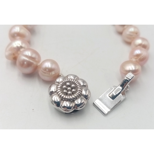 1046 - A Cultured Pink Pearl Necklace with Silver Clasp. 52cm. ML17