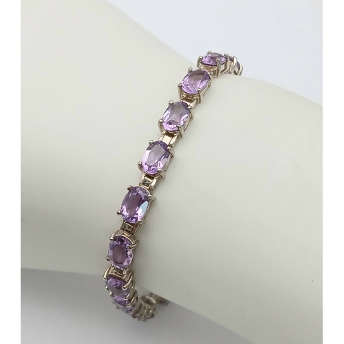519 - A Pretty Sterling Silver and Amethyst Set Tennis Bracelet. 19cm Length. Set with Twenty 6 x 5mm Oval... 