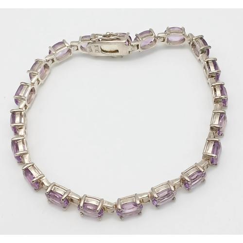 519 - A Pretty Sterling Silver and Amethyst Set Tennis Bracelet. 19cm Length. Set with Twenty 6 x 5mm Oval... 