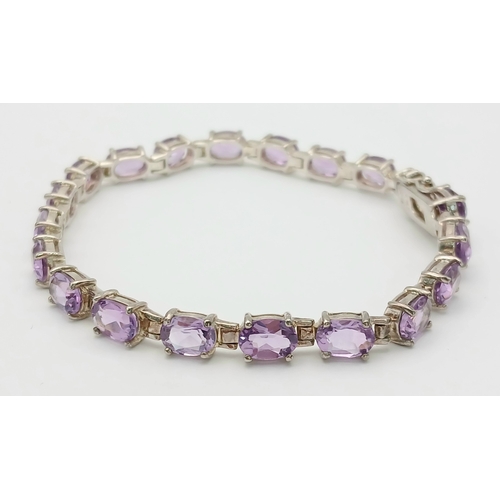 519 - A Pretty Sterling Silver and Amethyst Set Tennis Bracelet. 19cm Length. Set with Twenty 6 x 5mm Oval... 