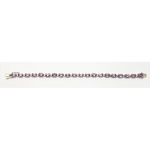 519 - A Pretty Sterling Silver and Amethyst Set Tennis Bracelet. 19cm Length. Set with Twenty 6 x 5mm Oval... 