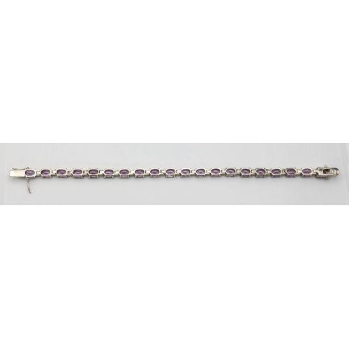 519 - A Pretty Sterling Silver and Amethyst Set Tennis Bracelet. 19cm Length. Set with Twenty 6 x 5mm Oval... 