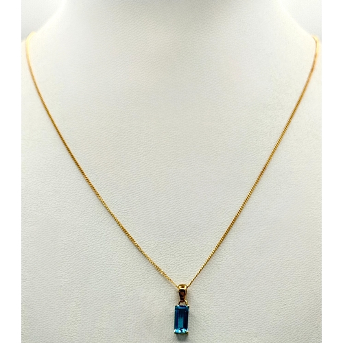 557 - A Stylish 9 Carat Gold Blue Topaz Set Pendant Necklace, 41cm Length Chain. Pendant measures 1.4cm Dr... 