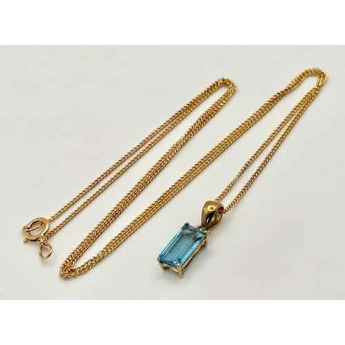 557 - A Stylish 9 Carat Gold Blue Topaz Set Pendant Necklace, 41cm Length Chain. Pendant measures 1.4cm Dr... 