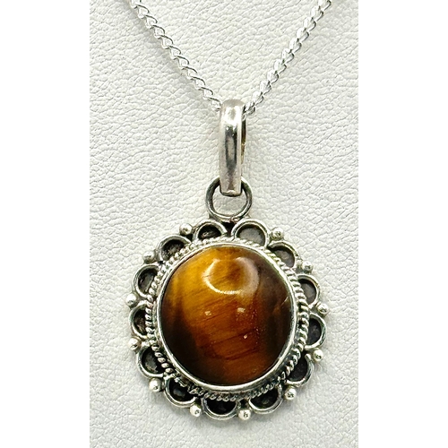 1000 - A Vintage Sterling Silver and Tigers Eye Pendant on a later Sterling Silver 46cm Length Chain. Penda... 