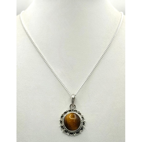 1000 - A Vintage Sterling Silver and Tigers Eye Pendant on a later Sterling Silver 46cm Length Chain. Penda... 