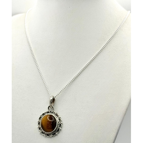 1000 - A Vintage Sterling Silver and Tigers Eye Pendant on a later Sterling Silver 46cm Length Chain. Penda... 