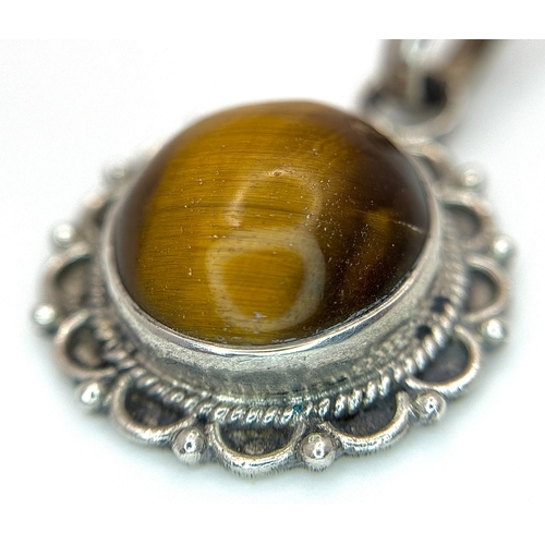 1000 - A Vintage Sterling Silver and Tigers Eye Pendant on a later Sterling Silver 46cm Length Chain. Penda... 