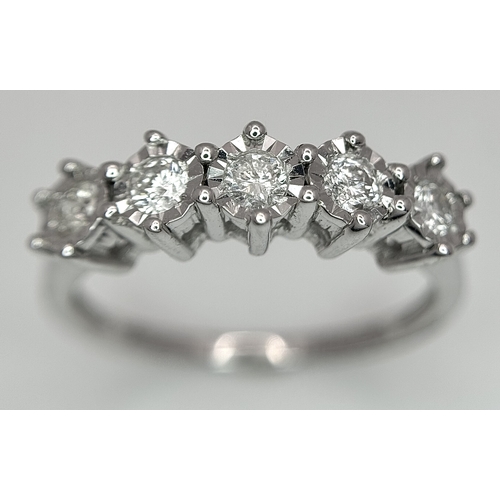 1012 - A 9K White Gold Five Stone Diamond Ring. Size O. 2.7g. NL16/11206.