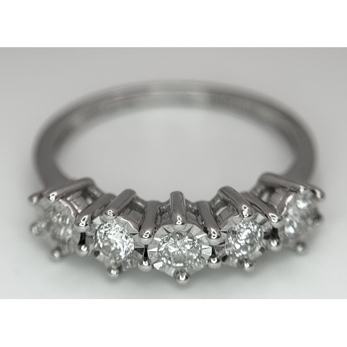 1012 - A 9K White Gold Five Stone Diamond Ring. Size O. 2.7g. NL16/11206.