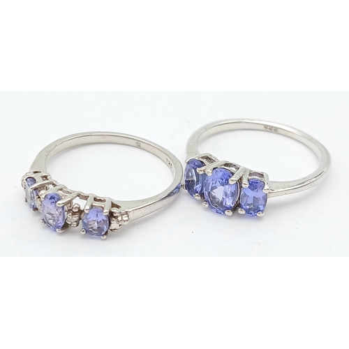 1010 - 2X silver fancy Tanzanite trilogy stone set rings. Total weight 3.1G. Size K.