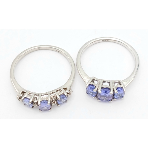 1010 - 2X silver fancy Tanzanite trilogy stone set rings. Total weight 3.1G. Size K.