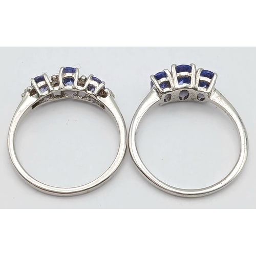 1010 - 2X silver fancy Tanzanite trilogy stone set rings. Total weight 3.1G. Size K.