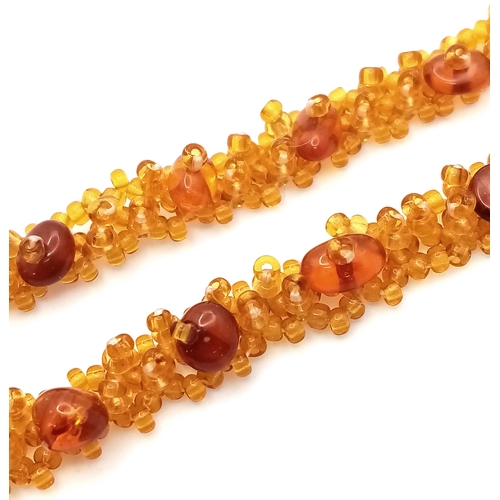 1406 - A pretty Baltic amber beads necklace. New condition. Approx 48cm length. Handmade in Russia.