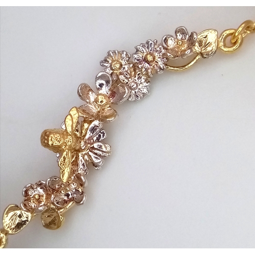 115 - An Alex Monroe, Designer Gilded Bracelet with Hanging Floral Form Pendant. 18cm in length. Comes wit... 