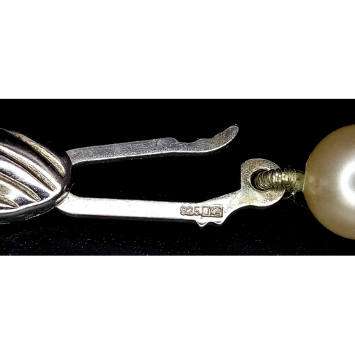 1031 - A Vintage Pearl Necklace with Silver Clasp. 56cm.