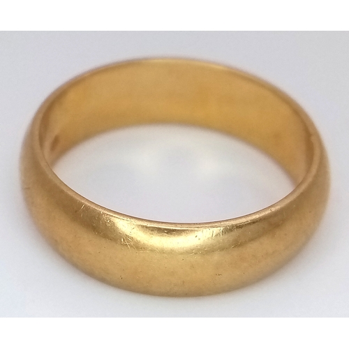 25 - An 18K Yellow Gold Band Ring. Full UK hallmarks. 6mm width. Size O. 6.35g.