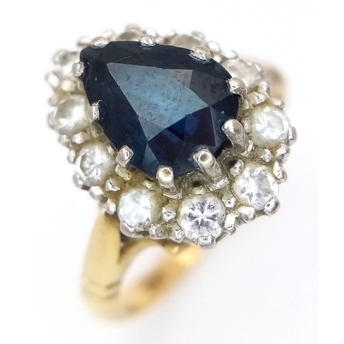 46 - An 18K Yellow Gold Diamond and Sapphire Ring. A 1.5ct pear-shaped sapphire with a 0.50ctw diamond su... 