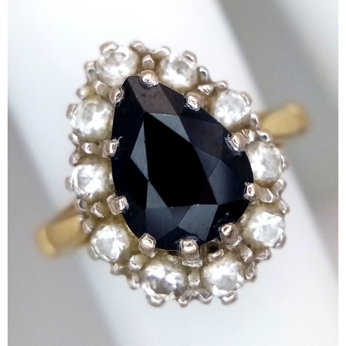 46 - An 18K Yellow Gold Diamond and Sapphire Ring. A 1.5ct pear-shaped sapphire with a 0.50ctw diamond su... 
