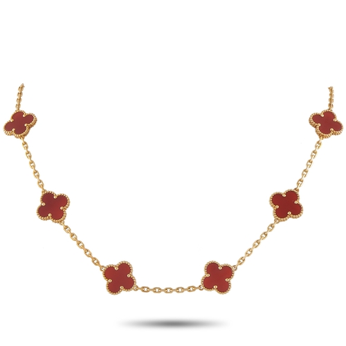 A Van Cleef & Arpels AlhambrAn 18K Yellow Gold Carnelian 10-Motif Necklace. A series of 10 of the luxury brands iconic clover motifs come to life in Carnelian a vibrant reddish-orange stone. The stones radiant color complements this pieces impeccably crafted 18K Yellow Gold setting. It measures 16.5 inches long and includes lobster clasp closure. In estate condition and includes a gift pouch & papers. *This item is held at Cadmore USA Office in Pennsylvania, USA and will be shipped from there. Buyers will be responsible for direct shipping payments.*
