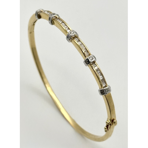 65 - An 18K Yellow Gold and Diamond Bangle. 1ctw of tapered baguette and round brilliant cut diamonds. Cl... 