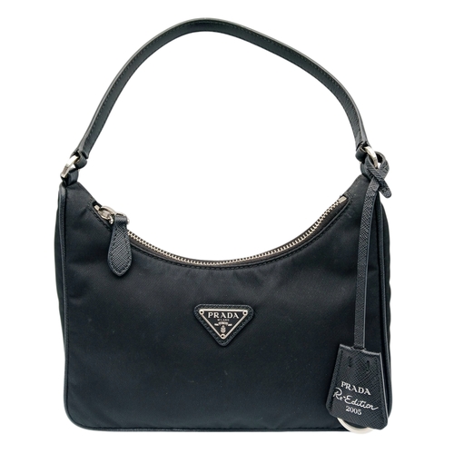 68 - A Prada Re-Edition Black Nylon Shoulder Bag. Black nylon exterior with silver-toned hardware, single... 