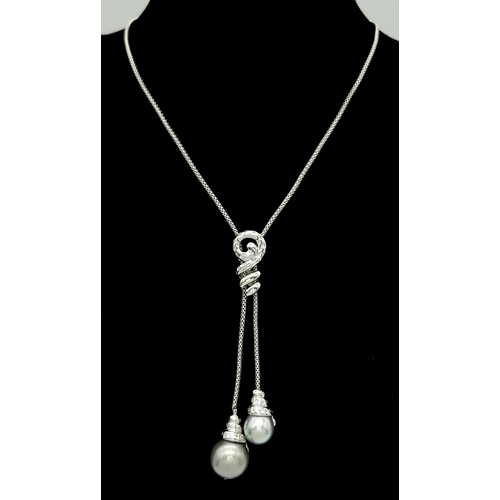 86 - An 18K White Gold, Pearl and Diamond Necklace. Fancy Venetian links with a diamond encrusted serpent... 