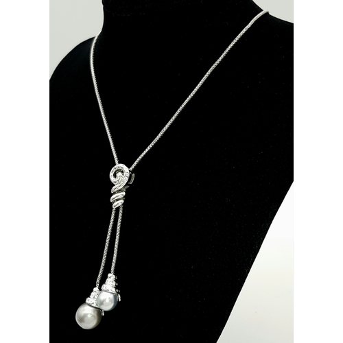 86 - An 18K White Gold, Pearl and Diamond Necklace. Fancy Venetian links with a diamond encrusted serpent... 