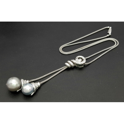 86 - An 18K White Gold, Pearl and Diamond Necklace. Fancy Venetian links with a diamond encrusted serpent... 