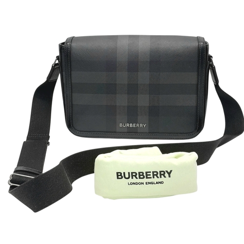 96 - A Burberry Black London Check Crossbody Bag. Black coated canvas exterior with silver-toned hardware... 