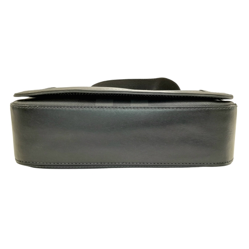96 - A Burberry Black London Check Crossbody Bag. Black coated canvas exterior with silver-toned hardware... 
