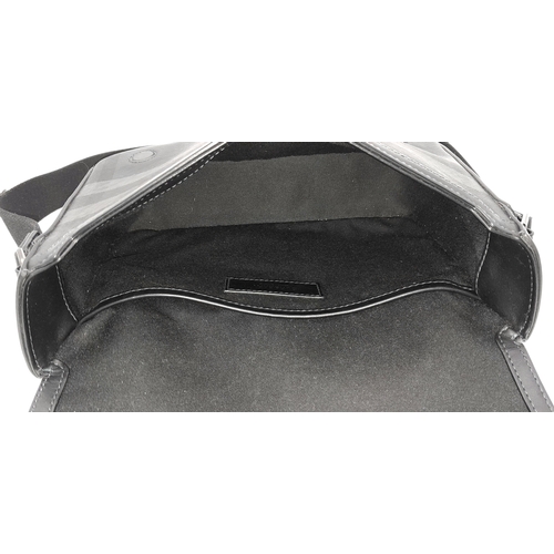 96 - A Burberry Black London Check Crossbody Bag. Black coated canvas exterior with silver-toned hardware... 
