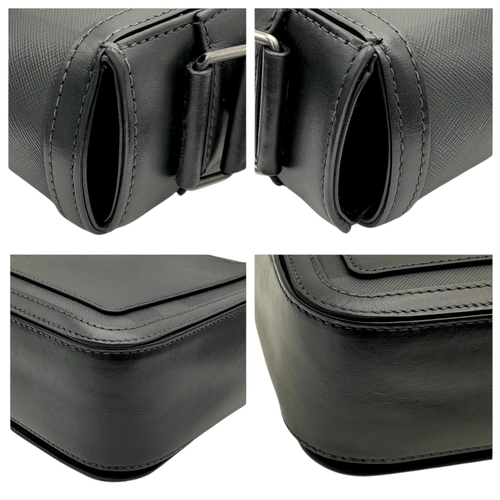 96 - A Burberry Black London Check Crossbody Bag. Black coated canvas exterior with silver-toned hardware... 