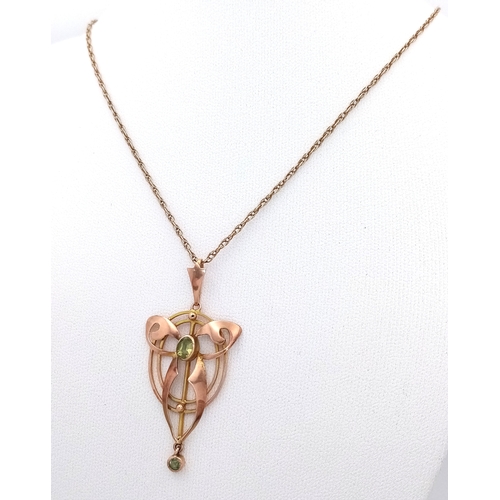 103 - An Antique Edwardian Pendant set with a Central Oval Cut Peridot. Stylistic open work design - 4.5cm... 