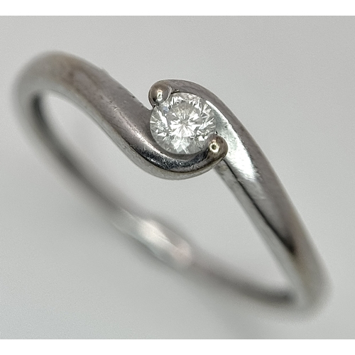 106 - An 18K White Gold Diamond Crossover Solitaire Ring. Size M. Brilliant round cut diamond c. 0.10ct. 1... 