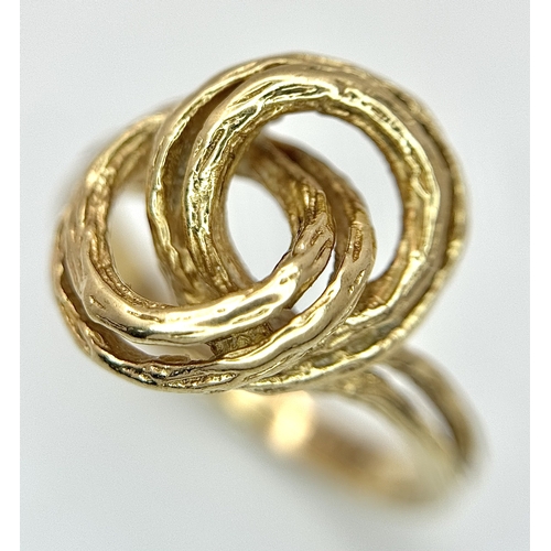 107 - A 9K Yellow Gold Swirl Ring. Size K. 3.2g.